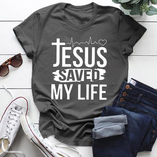 Jesus Saved My Life Short Sleeve T-shirt displayed on a flat lay with sunglasses and sneakers