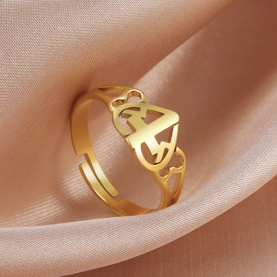 Stainless Steel Love Cross Ring displayed elegantly on satin fabric.