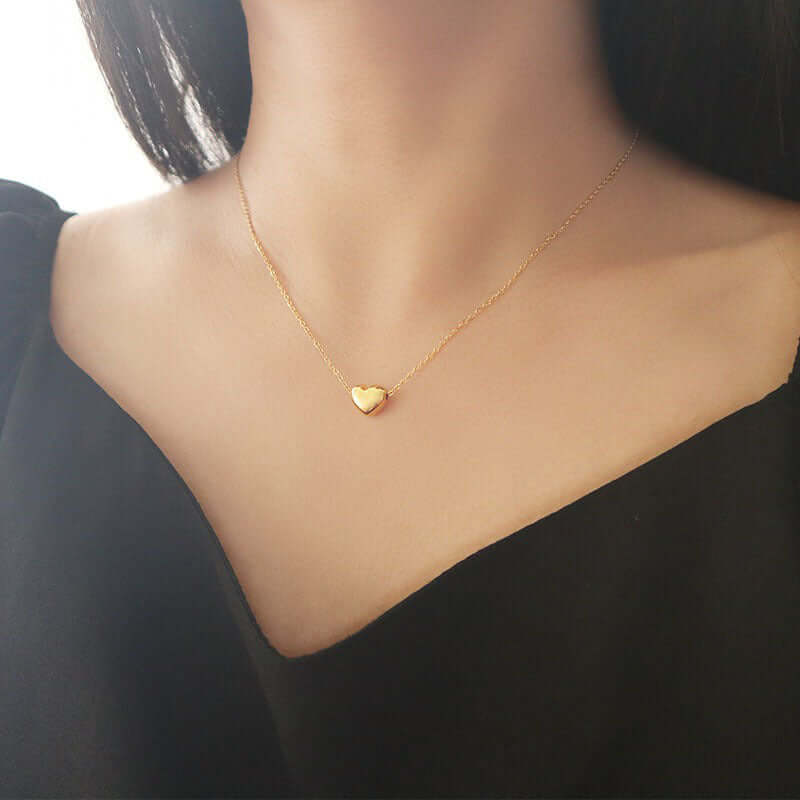 3D love heart pendant necklace worn elegantly, showcasing its sophisticated design and golden finish.