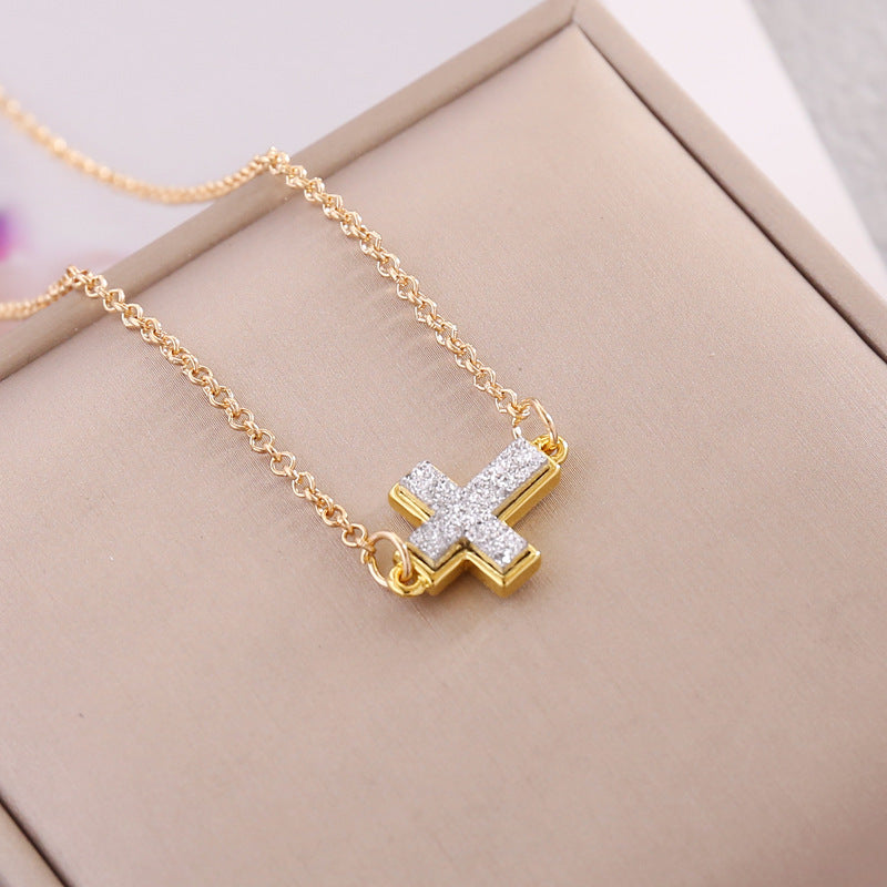 Multicolor Cross Necklace displayed on a jewelry box, featuring a shimmering gold and diamond pendant.