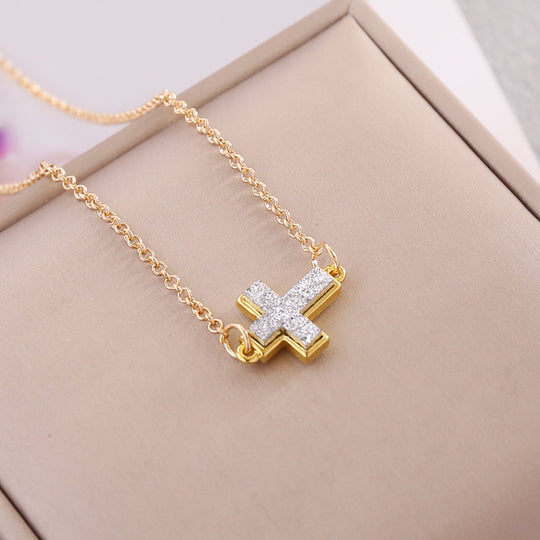 Multicolor Cross Necklace displayed on a jewelry box, featuring a shimmering gold and diamond pendant.